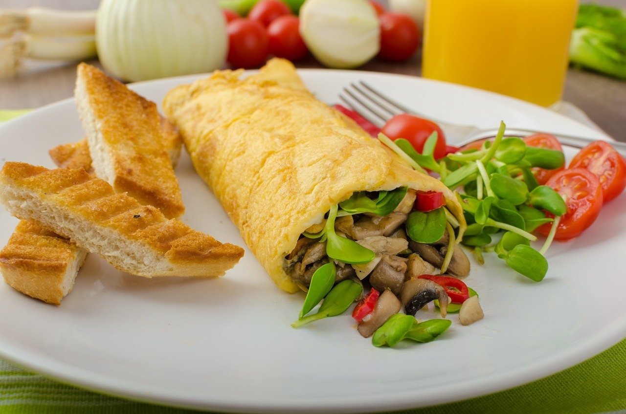 Omelette stuffed with mushrooms and clover microgreens