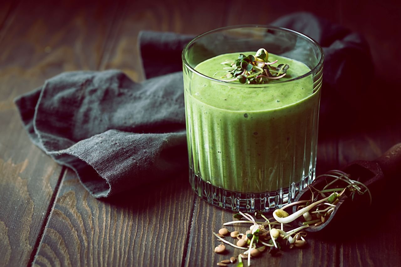 healthy-green-smoothie colorful microgreens varieties arranged on a clean kitchen surface