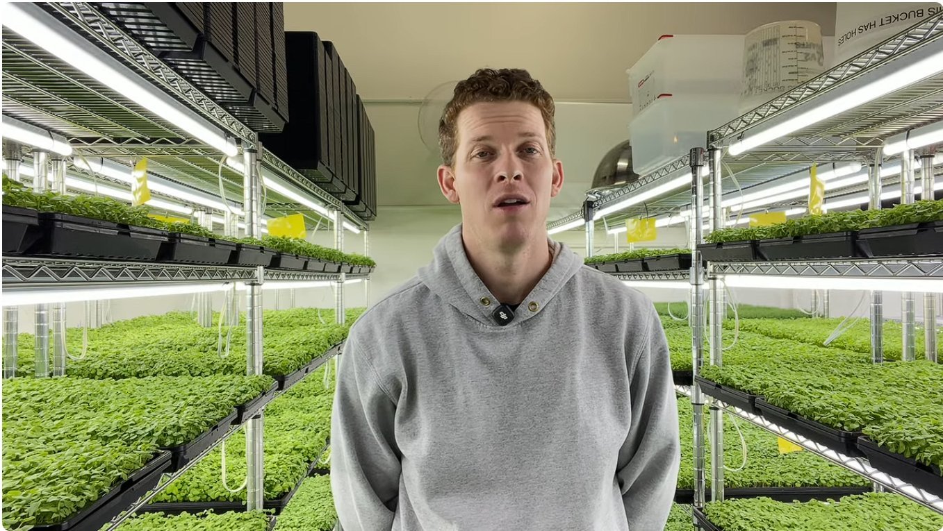 what is microgreen manager Garrett Corbin standing in indoor vertical farm facility